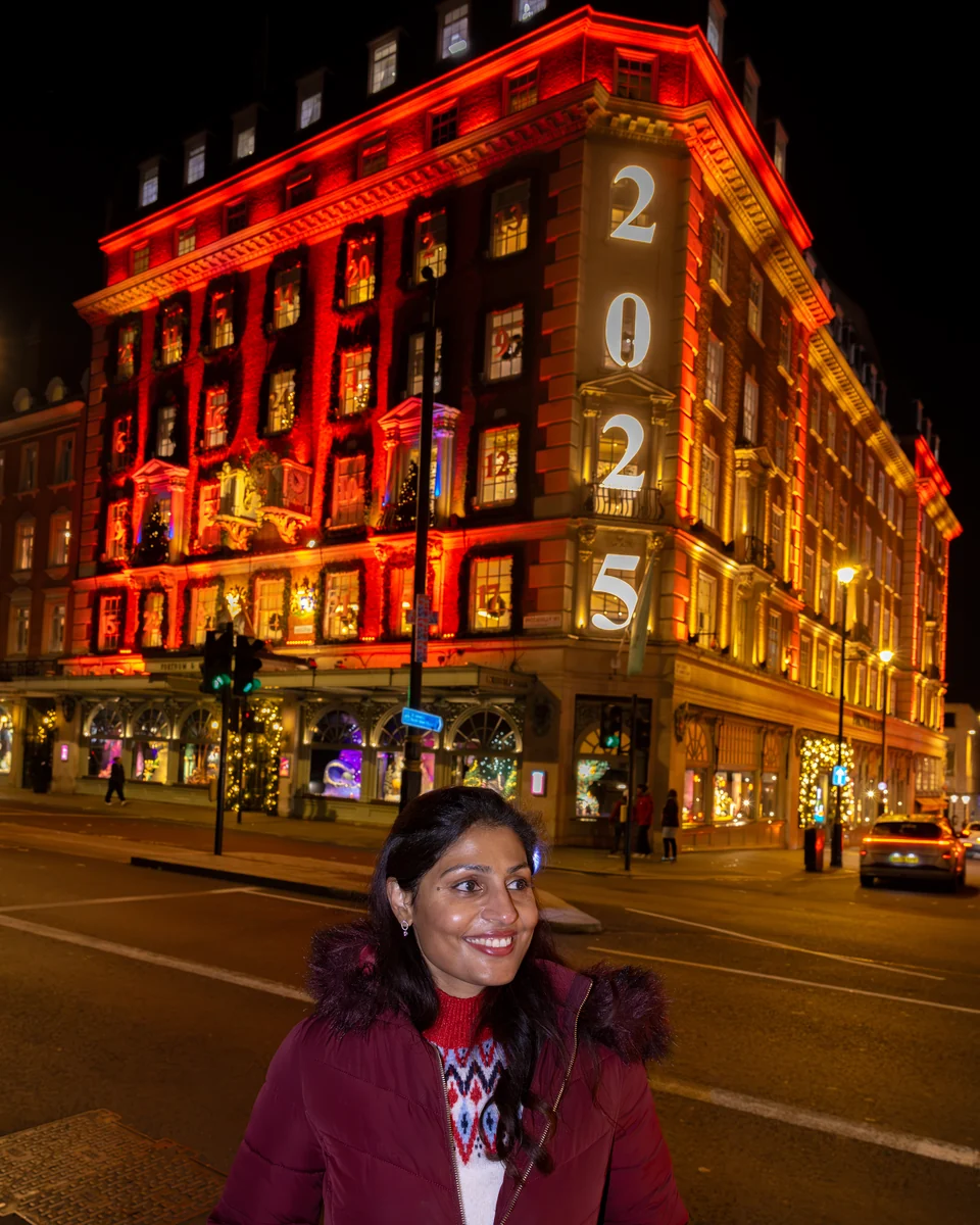 Matty outside Fortnum & Mason with its illuminated Christmas frontage.