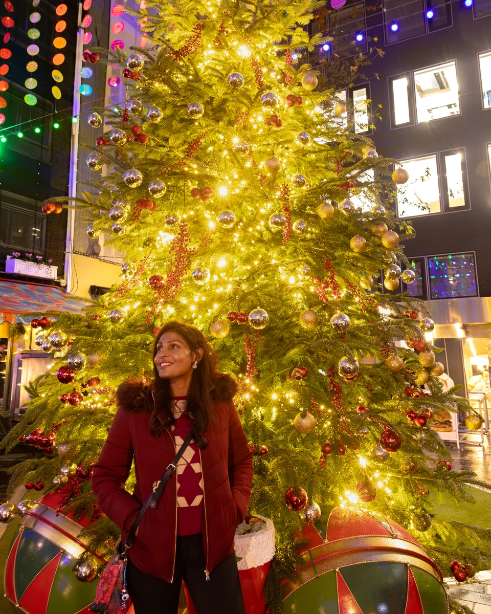 Matty beside the festive red Mini and Christmas tree at St Christopher’s Place.