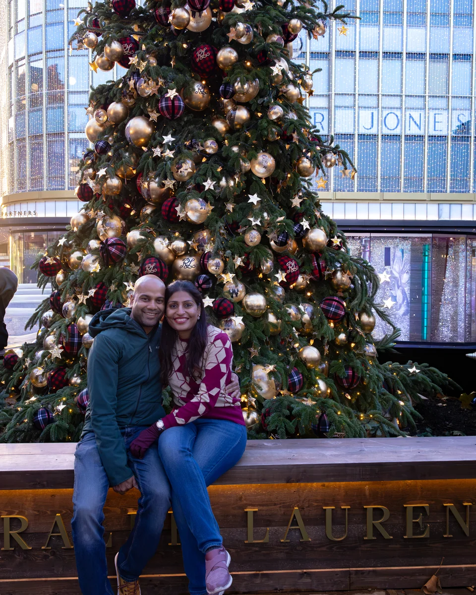 The couple beside the decorated Ralph Lauren Christmas tree on New Bond Street.