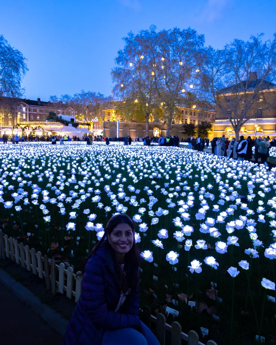 Matty beside the illuminated white roses at Ever After Garden in Duke of York Square, Chelsea, during our 2025 visit.