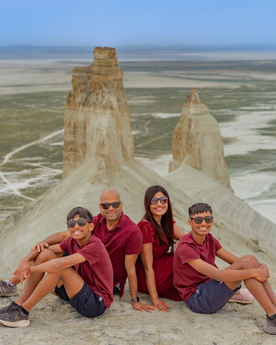Our family of four in burgundy outfits beside the chalk formations in Mangystau, Kazakhstan.